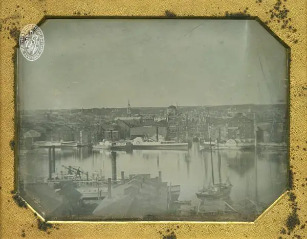 Baltimore Harbor view. Gay Street dock from Federal Hill, Baltimore. Attributed to Henry H. Clark. Full plate daguerreotype. Shows ships Herald and Juniata, Merchant's Exchange building (demolished ca. 1901-1902), and Second Reformed Church.