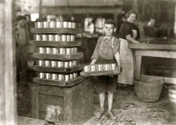 July 1909. Baltimore, Md. "One of the small boys in J.S. Farrand Packing Co. and a heavy load. J.W. Magruder, witness." Photo: Lewis Wickes Hine.