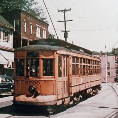 This double-ended, 1918 vintage Baltimore Traction Company Brill streetcar has just begun its in-bound journey from Ellicott City, Maryland, heading east to Baltimore on the No. 9 line. Positioned here at 8304 Main Street, car 5706 is about to plunge down a fairly steep grade (about 5%) that bottoms out at the Patapsco River crossing seen here. It must climb a longer but less arduous slope on the other side.