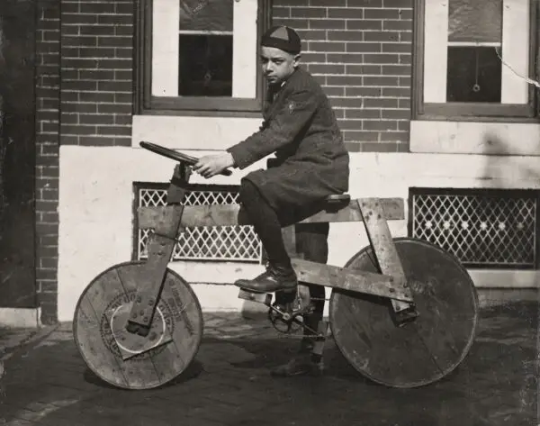 Bernard J. "Boompy" Logue of 2527 E. Monument St. in Baltimore, MD, about 1920, on his home made bicycle.