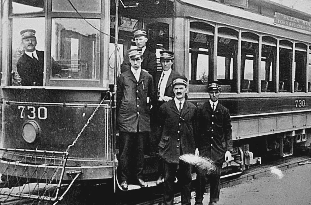 Catonsville, Maryland, C. 1915. These no-nonsense chaps manned streetcars for the Baltimore Traction company. In those days, two-man crews were the norm, with a motorman at the tiller and a conductor to collect tickets and to be the first line of customer service. The car's signage references Hillen, York, and Frederick Roads, all of which still exist today in the city of Baltimore. Without additional documentation, it's not clear exactly how a streetcar would traverse those as part of one route. 