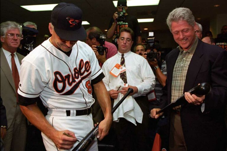 Baltimore Orioles player Cal Ripken autographs a baseball bat for President Clinton after Ripken broke the consecutive game streak at 2,131 games. 9/6/95.
