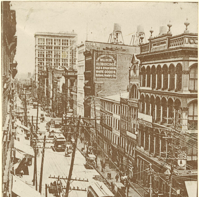 Photograph that features a view of Baltimore Street west of Hanover Street on Baltimore before the fire of 1904. Conspicuous landmarks are the Continental Building, now the Mercantile Trust Company, and the business house of Armstrong Cator & Co. west of Charles Street.